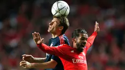 Penyerang Muenchen, Thomas Muller (kiri) berebut bola udara dengan gelandang Benfica, Mehdi Carcela Gonzalez di leg kedua Liga Champions di Stadion Da Luz, Lisboa, Portugal, Kamis (14/4). (Reuters/Rafael Marchante)