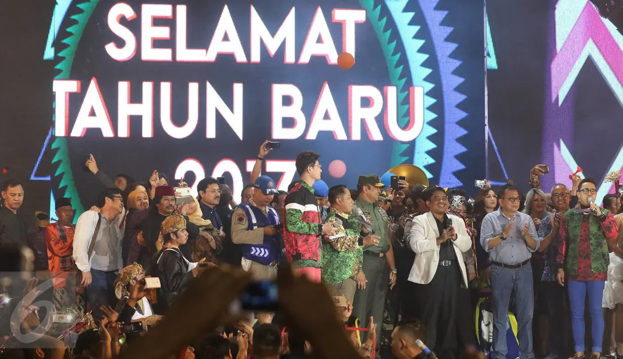 Plt Gubernur DKI Jakarta Soni Sumarsono bersama sejumlah pengisi acara memeriahkan konser pergantian tahun Gempita 2017 di Ancol, Jakarta, Minggu (1/1). Perayaan malam tahun baru di Ancol juga dimeriahkan pesta kembang api. (Liputan6.com/Angga Yuniar)
