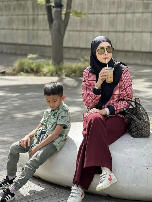 Mengenakan busana nuansa maroon, motif houndstooth pada blouse membuat gaya sederhananya terlihat lebih menarik.  [Foto: instagram/ Fenita Arie]