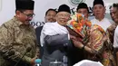 Budayawati Sukmawati Soekarnoputri mengenakan kerudung berwarna oranye mencium tangan Ketua MUI KH Ma'ruf Amin usai pertemuan dengan MUI di kantor MUI, Jakarta, Kamis (5/4). (Liputan6.com/Angga Yuniar)