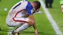 Gelandang Amerika Serikat, Christian Pulisic, tampak kecewa usai kalah dari Trinidad Tobago pada laga kualifikasi Piala Dunia di Stadion Ato Boldon, Selasa (10/10/2017). Trinidad dan Tobago menang 2-1 atas  Amerika Serikat. (AFP/Ashley Allen)