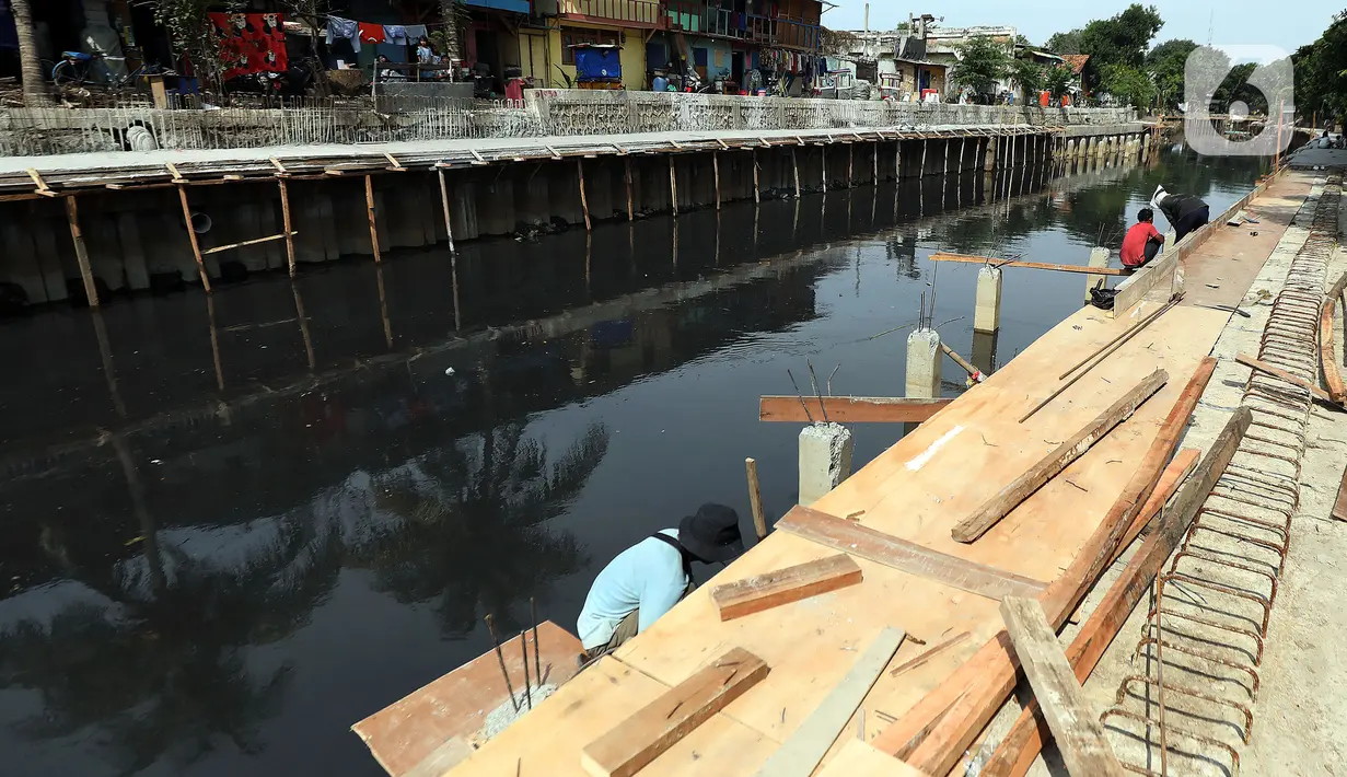 Pekerja mengerjakan proyek pembangunan tanggul bantaran Kali Anak Ciliwung di RT 001 RW 008 Ancol, Pademangan, Jakarta Utara, Kamis (19/12/2019). Pembangunan tanggul untuk mencegah amblesnya bantaran sungai seperti pada akhir tahun 2018 lalu. (Liputan6.com/Johan Tallo)