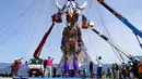 Pekerja mengatur boneka raksasa MOCCO saat sesi latihan khusus di Takamori, Prefektur Nagano, Jepang, Jumat (23/4/2021). Boneka tersebut akan melakukan perjalanan dari Tohoku ke Tokyo pada bulan Mei untuk Olimpiade Tokyo yang dijadwalkan dibuka pada bulan Juli. (AP Photo/Koji Ueda)