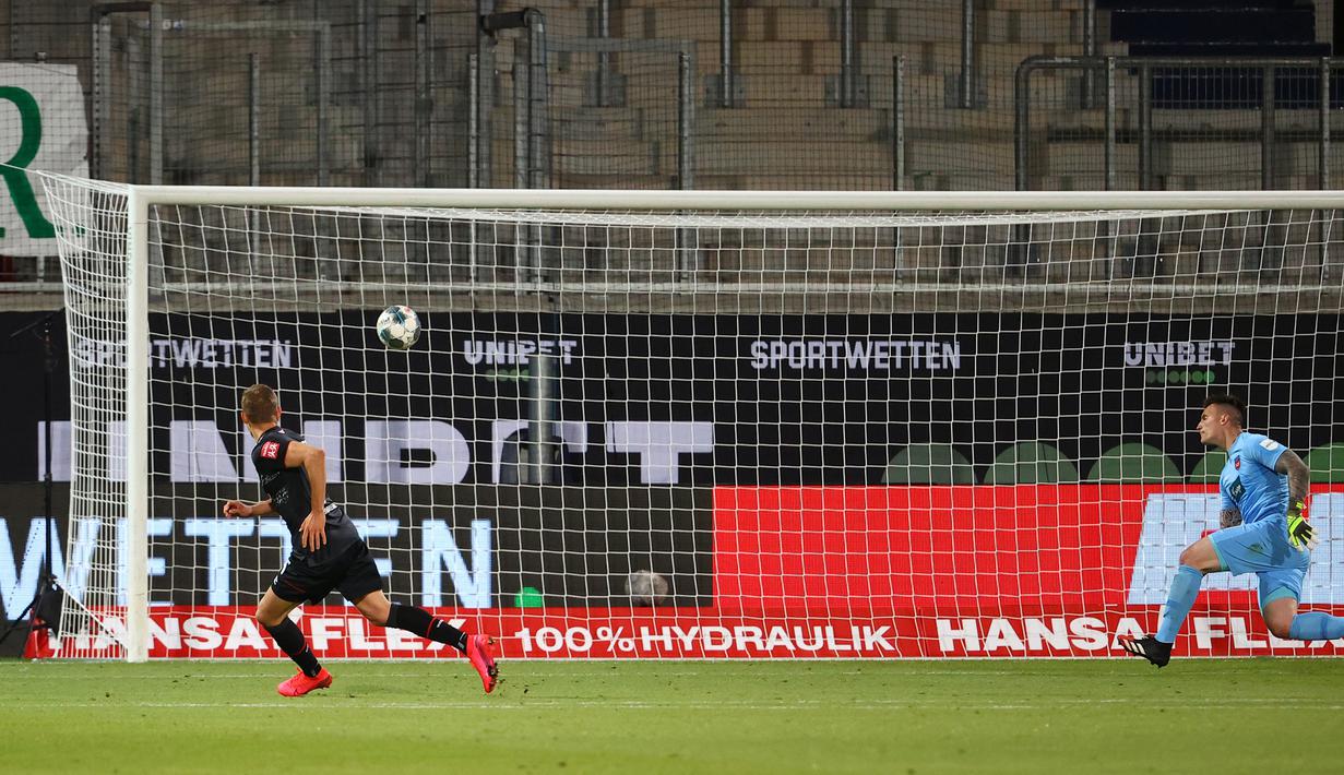 Bek werder Bremen, Ludwig Augustinsson, saat mencetak gol ke gawang Heidenheim 1846 pada laga lay-off leg kedua di Voith-Arena, Selasa (7/7/2020) dini hari WIB. Bremen bermain imbang 2-2 atas Heidenheim. (AFP/Kai Pfaffenbach/pool)
