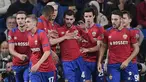 Para pemain CSKA Moskow merayakan gol yang dicetak Georgy Shchennikov ke gawang Real Madrid pada laga Liga Champions di Stadion Santiago Bernabeu, Madrid, Rabu (12/12). Madrid kalah 0-3 dari CSKA. (AFP/Javier Soriano)