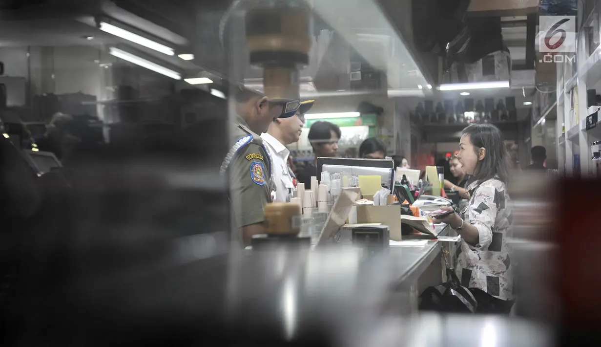 Petugas BPOM (Balai Pengawas Obat dan Makanan) bersama Polres Jakarta Pusat, Dinas Kesehatan dan Satpol PP memeriksa kosmetik saat melakukan razia di pertokoan Pasar Baru, Jakarta, Rabu (12/12). (Merdeka.com/Iqbal S. Nugroho)