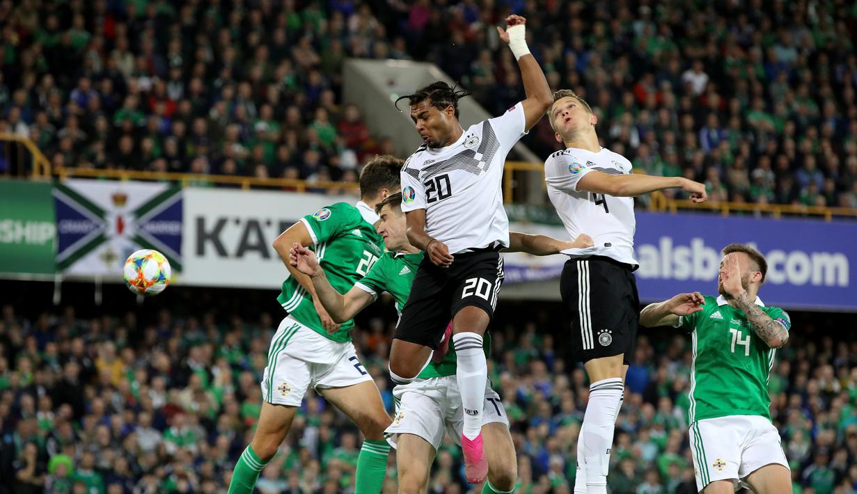 Gelandang dan bek Jerman, Serge Gnabry (tengah) dan Matthias Ginter (dua kanan) menyundul bola udara saat menghadapi Irlandia Utara dalam kualifikasi Euro 2020 di Windsor Park, Belfast, Senin (9/9/2019). Jerman mengalahkan Irlandia Utara 2-0. (Paul Faith/AFP)