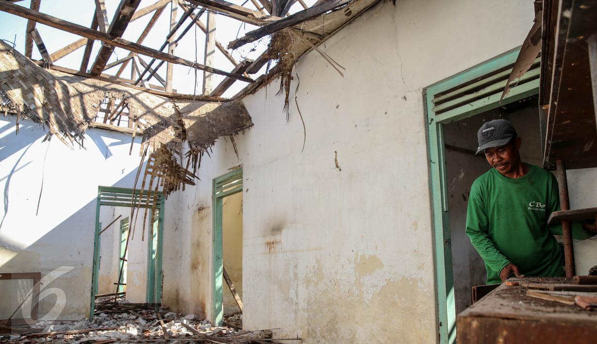 Warga membongkar sendiri rumah yang akan terkena dampak penggenangan Waduk Jatigede di Desa Cipaku, Sumedang, Jawa Barat, Senin (31/8/2015). Beberapa warga masih ada yang bertahan karena belum tuntasnya soal ganti rugi. (Liputan6.com/Faizal Fanani)