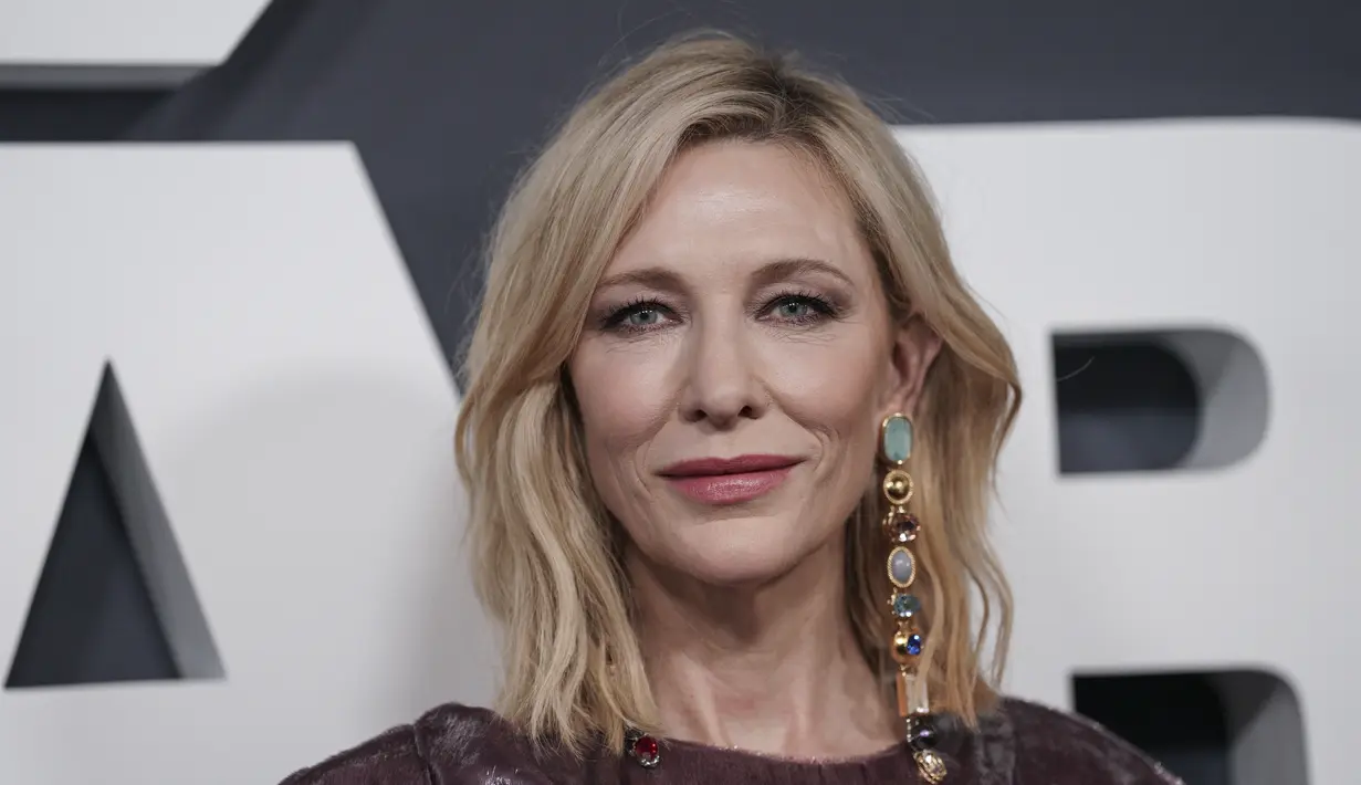 Cate Blanchett berpose untuk fotografer setibanya di pemutaran perdana film 'Tar' di London, Rabu, 11 Januari 2023.  Bintang itu menata rambut pirangnya menjadi ikal longgar. (Photo by Scott Garfitt/Invision/AP)