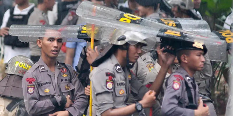 Jaga Aksi Hari Buruh Polisi Berlindung dengan Tameng Saat Hujan