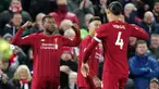 Pemain Liverpool Georginio Wijnaldum (kiri) merayakan golnya ke gawang West Ham bersama Virgil van Dijk pada pertandingan Liga Inggris di Stadion Anfield, Liverpool, Inggris, Senin (24/2/2020). Liverpool mengalahkan West Ham dengan skor 3-2. (AP Photo/Jon Super)