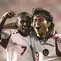 Boaz Solossa melakukan selebrasi dengan Ilham Jaya Kesuma saat melawan Laos di penyisihan grup Piala AFF 2004. (AFP/STR)
