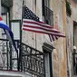 Bendera Kuba dan AS terlihat di balkon salah tempat warga di Havana, Kuba (20/3). Kunjungan Obama untuk membuka babak baru hubungan antar dua negara tersebut. REUTERS/Alexandre Meneghini)