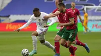 Striker Prancis, Kylian Mbappe, berusaha melewati pemain Bulgraria pada laga uji coba terakhir jelang Euro 2020 di Stade de France, Rabu (9/6/2021). Prancis menang dengan skor 3-0. (AP/Francois Mori)