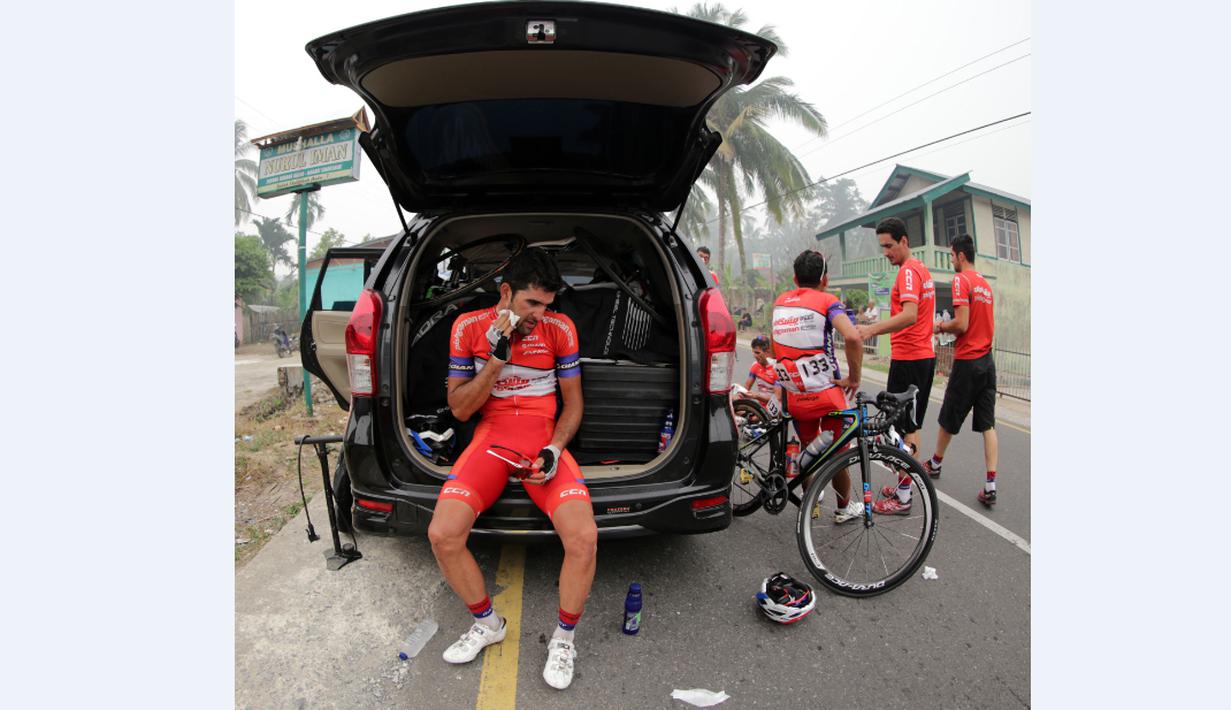 Pebalap Pishgaman Giant Team Iran, Amir Zargari, membersihkan diri setelah finis pertama di Etape 2 Tour de Singkarak 2015 dari Padang Pariaman menuju Solok, Sumatra Barat, Minggu (4/10/2015). (Bola.com/Arief Bagus)