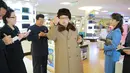 Kim Jong-un tampak menyampaikan sesuatu kepada sejumlah stafnya saat melakukan kunjungan dan keliling ke pusat perbelanjaan Mirae Shop yang baru dibangun di kompleks Mirae Shop di Korea Utara (28/3). (REUTERS/KCNA)