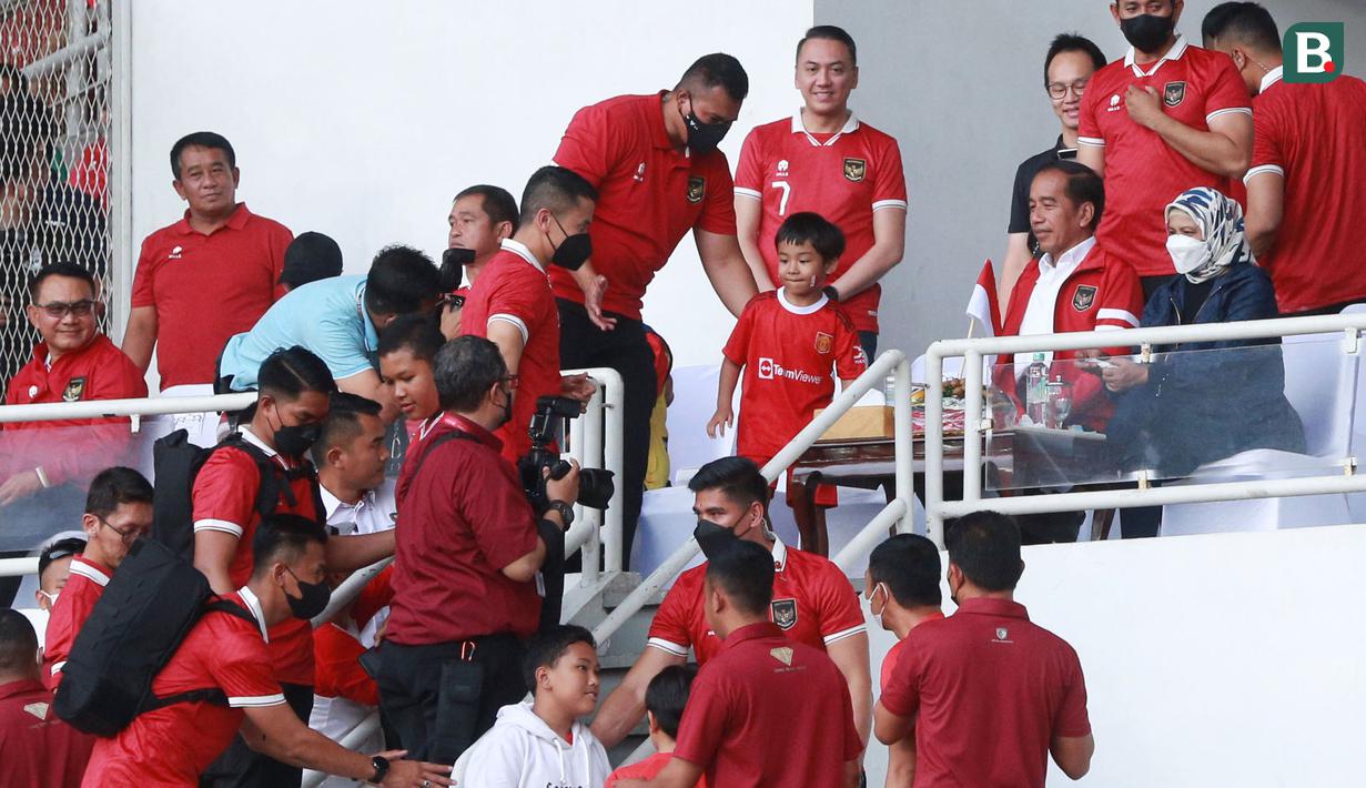 Presiden RI, Joko Widodo, menyempatkan diri melayani permintaan foto bersama suporter cilik di sela-sela rehat babak pertama pertandingan Timnas Indonesia melawan Thailand pada laga Piala AFF 2022 di Stadion Utama Gelora Bung Karno (SUGBK), Jakarta, Kamis (29/12/2022). (Bola.com/M Iqbal Ichsan)