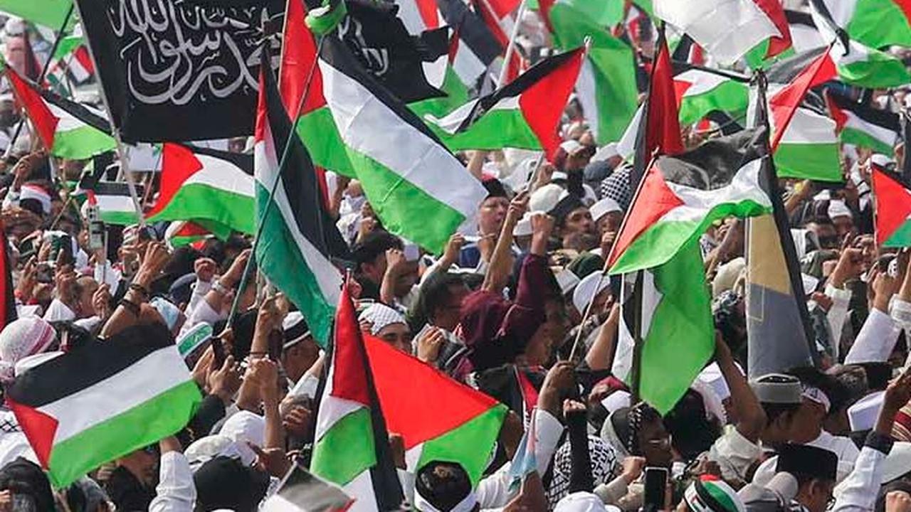Peserta Munajat Kubro 212 mengibarkan bendera Palestina di lapangan silang Monas, Jakarta, Sabtu (2/12/2023).