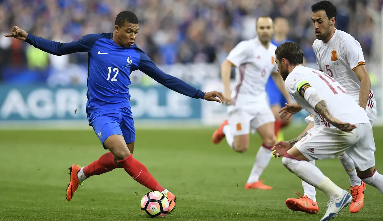 Striker Prancis, Kylian Mbappe, berusaha melewati pemain Spanyol. Pada laga tersebut Spanyol mendominasi pertandingan dengan penguasaan bola hingga 54 persen sementara Prancis hanya 46 persen. (AFP/ Christophe Simon)
