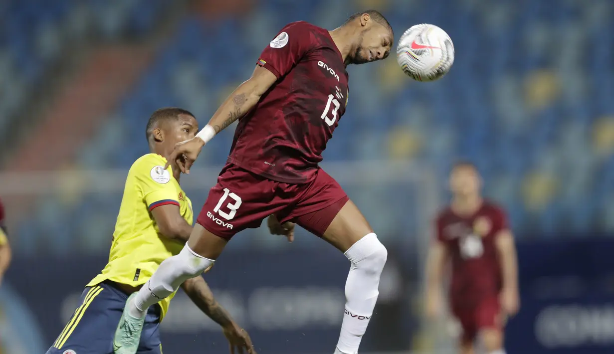 Penyerang timnas Venezuela, Jose Martinez dan gelandang Kolombia, Wilmar Barrios melakukan sundulan pada laga kedua Grup B Copa America 2021 di Estadio Olimpico Pedro Ludovico Teixeira, Golania, Brasil, Jumat (18/6/2021). Timnas Kolombia dan Venezuela bermain imbang 0-0. (AP Photo/Ricardo Mazalan)