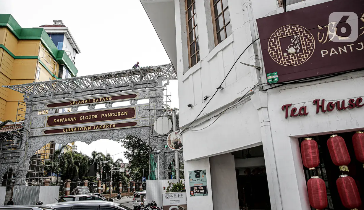 Sejumlah pekerja membangun gapura di Jalan Pancoran, Jakarta, Sabtu (11/6/2022). Pembangunan gapura tersebut bertujuan mempercantik kawasan Chinatown (Pecinan) Glodok Pancoran. (Liputan6.com/Faizal Fanani)