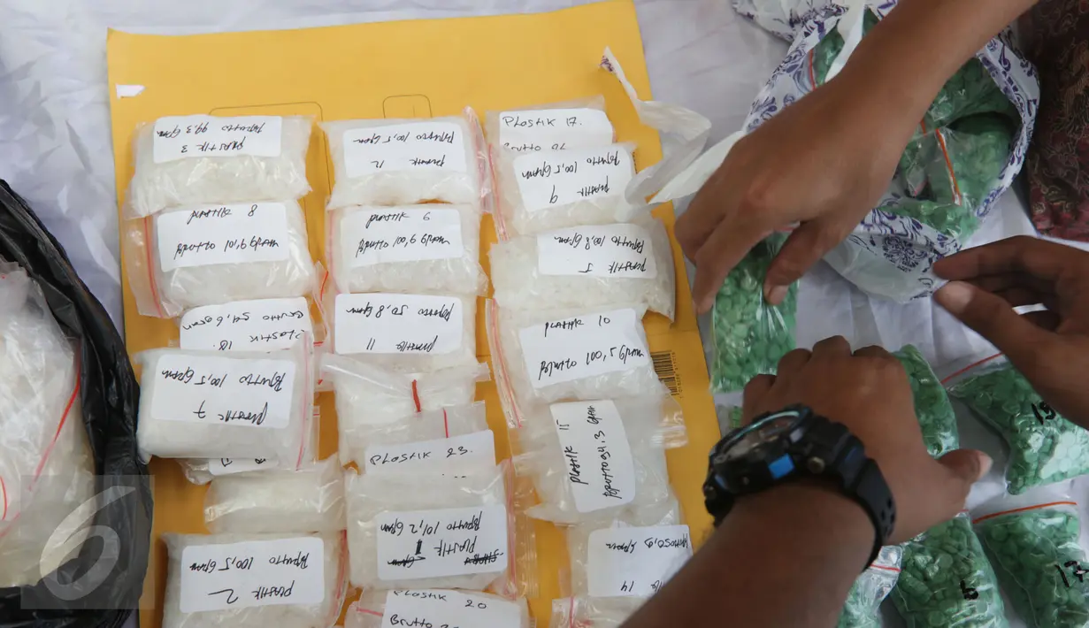 Dit Narkoba Polda Metro Jaya menata barang bukti hasil Operasi Bersinar Jaya 2016 di Jakarta, Rabu (13/4). Petugas mengungkap peredaran narkoba internasional dengan mengamankan 750 butir happy five senilai Rp202,608 miliar. (Liputan6.com/Gempur M Surya)