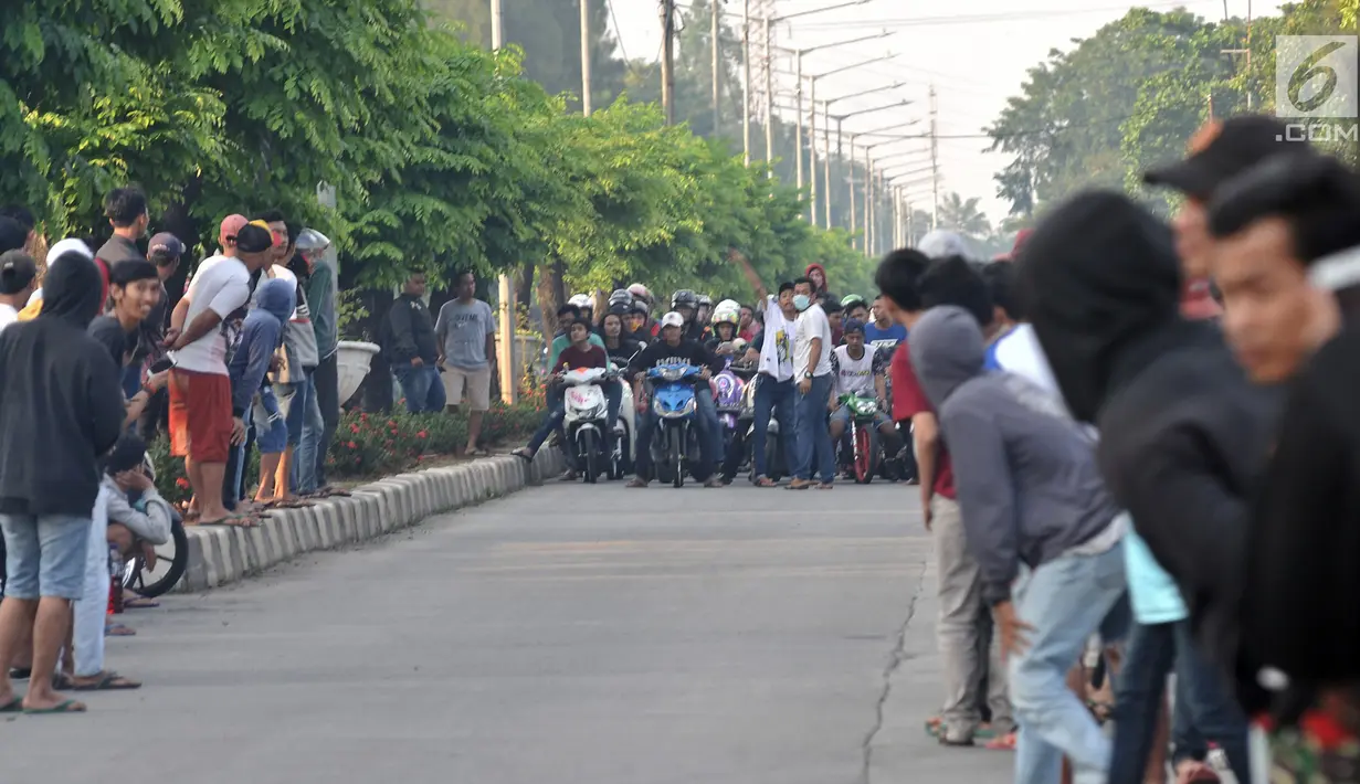 Pembalap bersiap memacu motornya saat ikut dalam balapan liar di Jakarta, Minggu (27/5) pagi. Balapan liar masih menjadi kegiatan favorit remaja di Ibu Kota dalam menghabiskan waktu Minggu pagi di bulan Ramadan. (Merdeka.com/Iqbal S Nugroho)