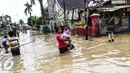 Warga melintas di kawasan banjir di Perumahan PGP Jatiasih, Bekasi, Jawa Barat, Jumat (22/4). Ketinggian air mencapai 1,5 meter dari sebelumnya ketinggian mencapai hampir 4 meter. (Liputan6.com/Fery Pradolo)