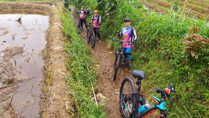 Nampak rombongan pengunjung asal Garut terlihat ceria, mereka memilih bergowes menuju kawasan wisata Curug Cisarua, Cilawu, Garut, Jawa Barat. (Liputan6.com/Jayadi Supriadin)