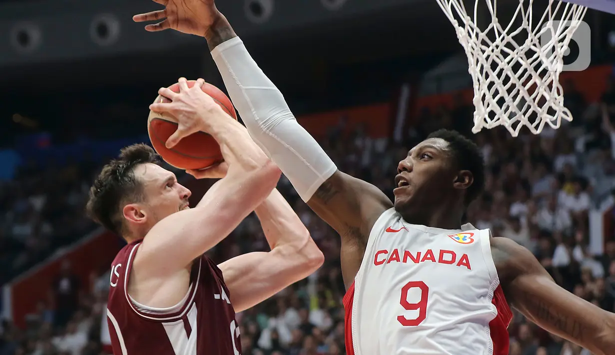 Pemain timnas basket Kanada, RJ-Barrett (kanan) berusaha menahan serangan pebasket Latvia, Rodions Kurucs pada laga terakhir penyisihan Grup H FIBA World Cup 2023 di Indonesia Arena, Gelora Bung Karno, Jakarta, Selasa (29/8/2023). (Liputan6.com/Helmi Fithriansyah)