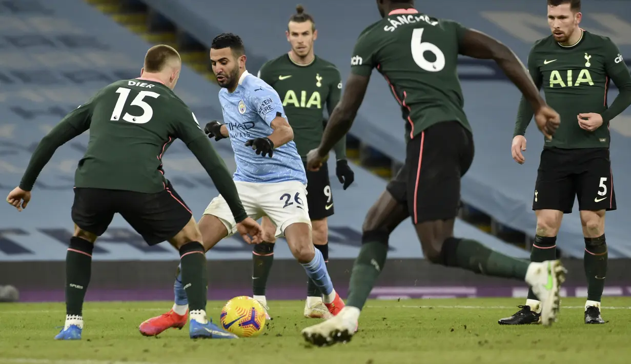 Gelandang Manchester City, Riyad Mahrez (kedua kiri) berusaha melewati para pemain Tottenham Hotspur pada pertandingan lanjutan Liga Inggris di Stadion Etihad, Manchester, Inggris, Minggu (14/2/2021).  Man City masih memuncaki klasemen sementara Liga Inggris dengan 50 poin. (AP Photo/Rui Vieira)