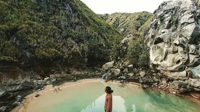 Seorang pendaki berada di kaki bukit Gunung Dukono
