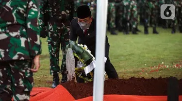 Menteri Sekretaris Negara (Mensesneg) RI Pratikno menaruh karangan bunga pada makam Menpan RB Tjahjo Kumolo saat prosesi pemakaman di Taman Makam Pahlawan Kalibata, Jakarta, Jumat (1/7/2022). Tjahjo Kumolo meninggal dunia di Rumah Sakit Abdi Waluyo Jakarta Pusat sekitar pukul 11.10 WIB. (Liputan6.com/Faizal Fanani)