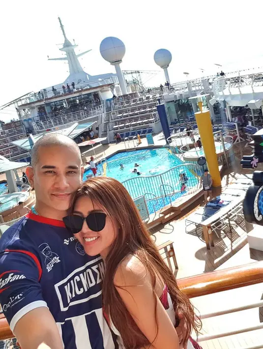 Dengan mesra sambil melemparkan senyumannya, Okan dan Lee begitu menikmati momen kebersamaan mereka. Terlihat di belakangnya terdapat kolam renang yang pastinya sangat pas untuk tempat berlibur. (Foto: Instagram)