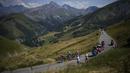 Pebalap tim Ineos Grenadiers, Thomas Pidcock (kiri) memimpin rombongan saat Stage 12 Tour de France 2022 yang menempuh rute sepanjang 165,1 km dari Briancon hingga L'Alpe-d'Huez, di Pegunungan Alpen, Prancis, Jumat (14/07/2022). (AP/Thibault Camus)