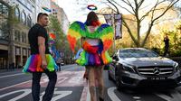 Seorang demonstran mengenakan sayap berwarna-warni saat mengikuti demo kesetaraan pernikahan sejenis di Sydney (10/9). Mereka turun kejalan untuk meminta kesetaraan pernikahan pasangan sesama jenis di Sydney. (AFP Photo/Saeed Khan)