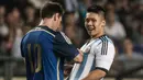 Seorang fan berhasil menyusup ke lapangan hijau dan mendapatkan tanda tangan Lionel Messi saat laga persahabatan antara Hong Kong vs Argentina. ( AFP/Anthony Wallace )