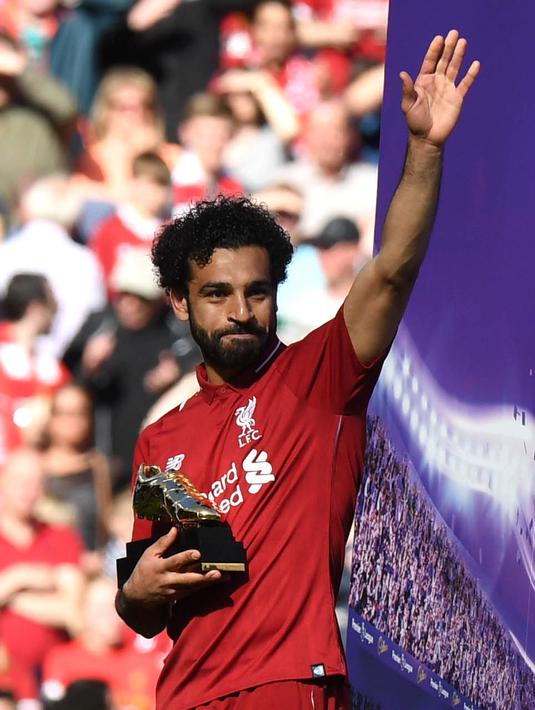 Penyerang Liverpool, Mohamed Salah, menyapa fans usai menerima trofi Sepatu Emas Premier League di Stadion Anfield, Minggu (13/5/2018). Salah menjadi top scorer Premier League musim ini dengan raihan 32 gol. (AFP/Paul Ellis)