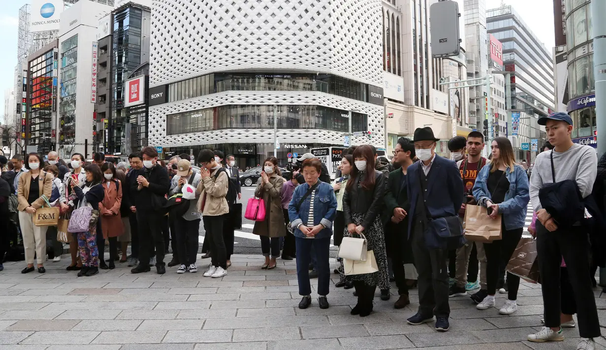 Warga berdoa untuk para korban gempa bumi dan tsunami 2011 di Distrik Perbelanjaan Ginza, Jepang, Rabu, 11 Maret 2020. Gempa 9,0 magnitudo yang menyebabkan tsunami pada 11 Maret 2011 itu menyebabkan sekitar 15 ribu orang tewas. (AP Photo/Koji Sasahara)