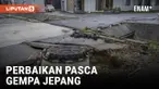 PARA PEKERJA MEMPERBAIKI PIPA AIR YANG RUSAK DAN MEMBERSIHKAN PUING-PUING TANAH LONGSOR PASCA GEMPA JEPANG