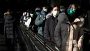 Orang-orang menggunakan eskalator di stasiun kereta bawah tanah di Beijing, Kamis (27/1/2022). Tahun Baru Imlek 2022 yang jatuh pada 1 Februari mendatang akan jadi tahun shio macan. (AFP/Noel Celis)