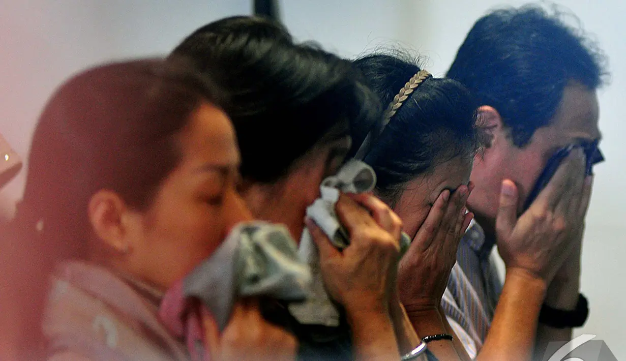 Isak tangis mengiringi pembacaan doa bersama sejumlah keluarga penumpang AirAsia QZ8501 melakukan doa bersama di Bandara Juanda, Surabaya, Senin (29/12/2014).(Liputan6.com/Johan Tallo)