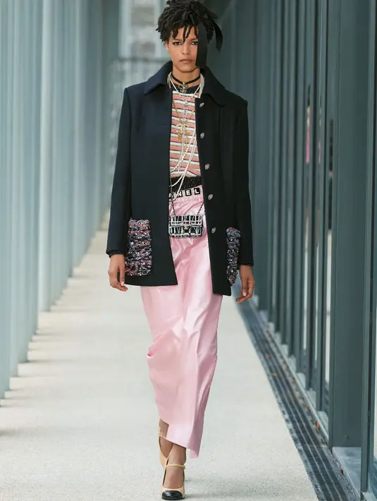 Gaya layering, dengan bermain tekstur terlihat pada hampir setiap look. Dari long loat dengan jewelled buttons, detail bordir pada area kantong, ditambah aksen mutiara dan woollen yarns. Uniknya, dipadukan dengan striped pastel alpaca sweater dan column skirt berwarna pink pucat berbahan kulit.