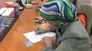 Mantan istri Mario Teguh, Ariyani sedang mengisi dokumen pemeriksaan guna menjalani tes DNA. Proses ini di tempuh demi membuktikan omongan Kiswinar terkait konflik dengan Mario Teguh. (Istimewa/dok. Bintang.com)