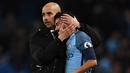 Pelatih Manchester City, Pep Guardiola memberikan dukungan kepada anak asuhnya Gael Clichy usai laga melawan Stoke City  pada lanjutan Premier League di Etihad Stadium, (8/3/2017). Manchester City bermain imbang 0-0.  (AFP/Paul Ellis)