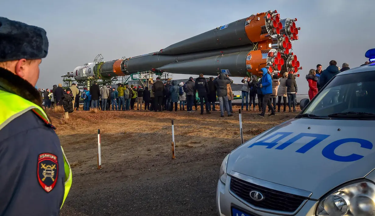 Sejumlah warga melihat pesawat ruang angkasa Soyuz MS-08 di Kosmodrome Baikonur, Kazakhstan, (19/3). Pesawat ini dijadwalkan meluncur pada 21 Maret dan berlabuh di Stasiun Luar Angkasa Internasional pada 23 Maret.  (AFP Photo/Vyacheslav Oseledko)