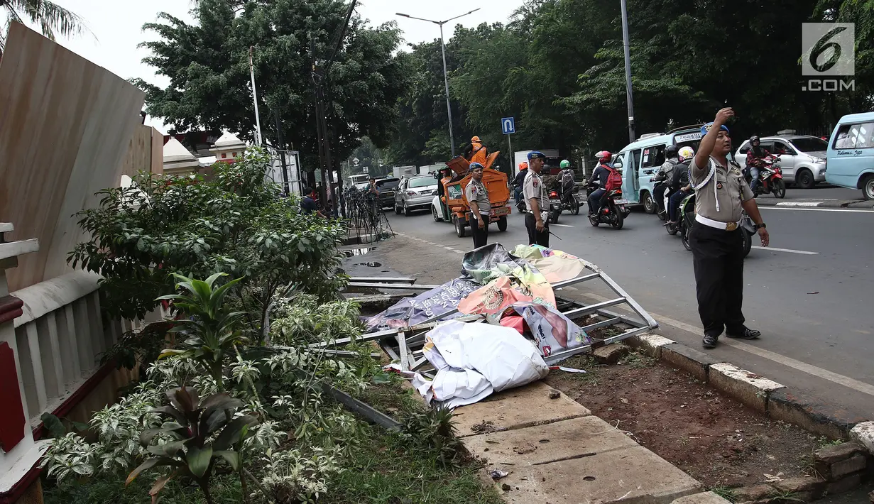 Petugas kepolisian mengatur arus lalu lintas di depan Polsek Ciracas seusai peristiwa amukan massa di Jakarta Timur, Rabu (12/12). Polsek Ciracas dirusak dan dibakar sekelompok massa tak dikenal pada dinihari tadi. (Liputan6.com/Herman Zakharia)