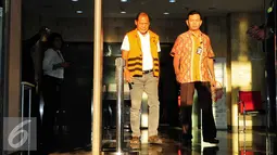 Made Meregawa mengenakan rompi tahanan dikawal petugas berjalan keluar gedung KPK usai diperiksa penyidik KPK, di Jakarta Selatan, Jumat (18/9/2015). Berkas Pemeriksaan lengkap Made Meregawa siap sidang di Bali. (Liputan6.com/Helmi Afandi)