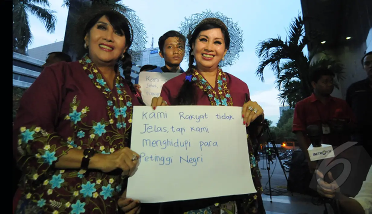Sepasang guru kembar menyambangi gedung KPK, Jakarta, Senin (26/1/2015). Kunjungan mereka sebagai bentuk dukungan kepada KPK. (Liputan6.com/Herman Zakharia)