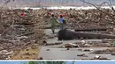 Gempa dan tsunami yang menghantam wilayah Aceh pada 26 Desember 2024 menjadi salah satu bencana alam paling mematikan di abad ke-21. (Foto oleh: CHOO Youn-Kong and Chaideer MAHYUDDIN/AFP)